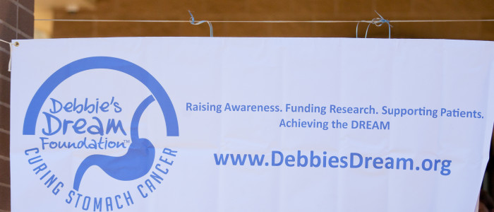 Debbie's Dream Foundation: Curing Stomach Cancer banner on display at 5K race